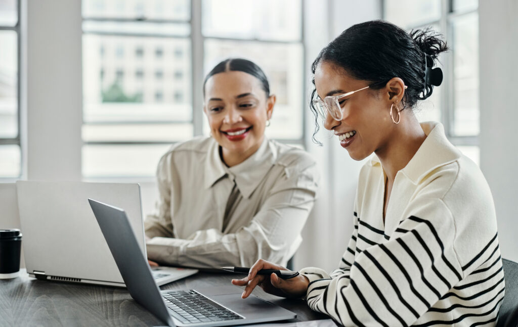 Business women, laptop and happy team in office for web design, collaboration, and training for customer service.