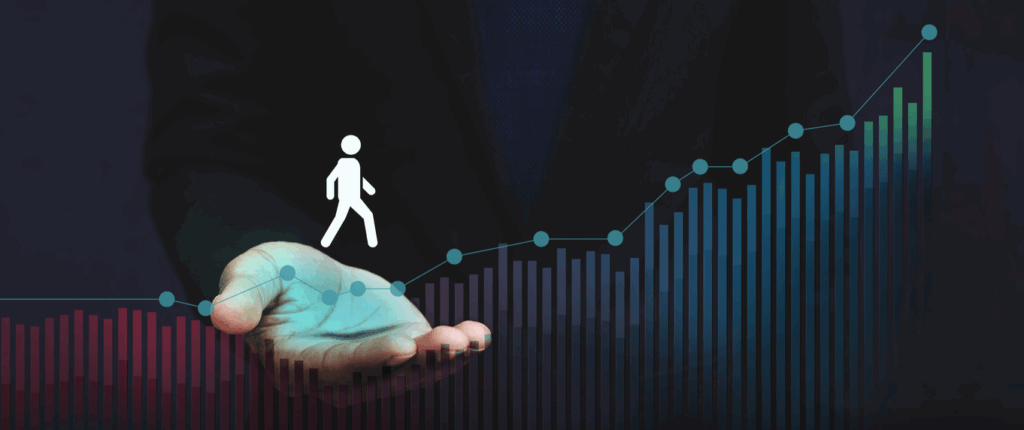 A man in a suit holds a graph depicting a person walking, symbolizing progress or growth in a professional context.