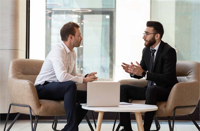 Middle,Eastern,And,Caucasian,Ethnicity,Businessmen,Seated,On,Armchair,In