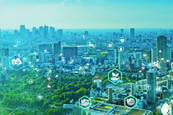 Birds eye view of a city with icons representing the sustainable development goals and green technology dotted across the city landscape