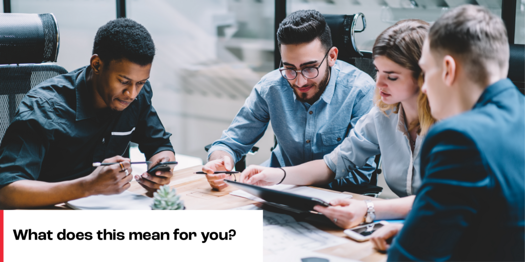 Group of diverse coworkers collaborating and brainstorming together over a boardroom table in the office. A text below reads "what does this mean for you"