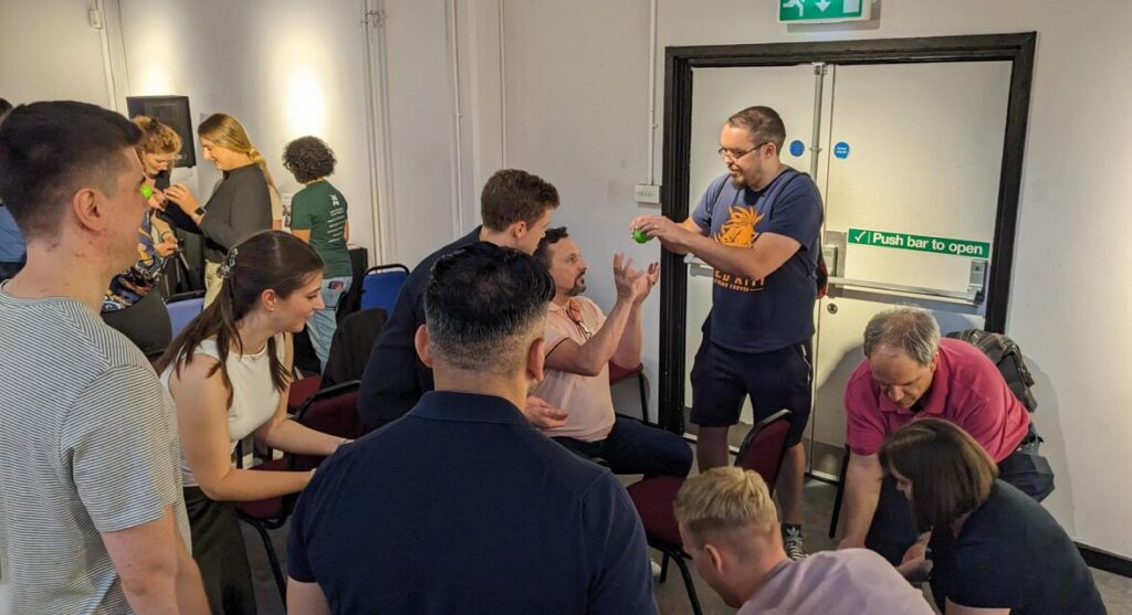 Team members taking part in the Ball Point Game, as a way to learn Agile methodology in an easy manner