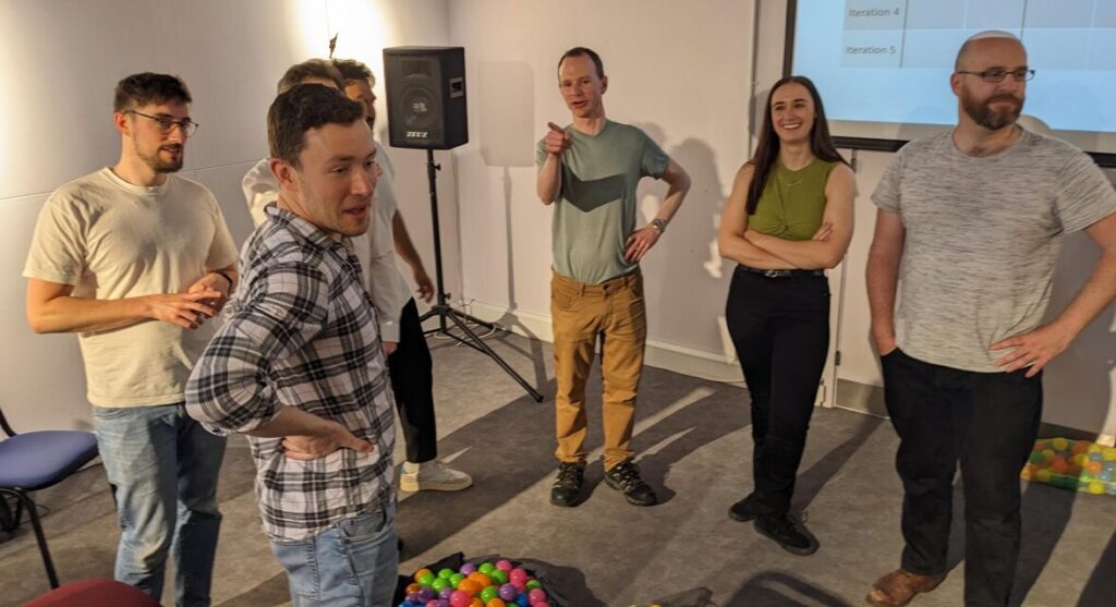 Team members taking part in the Ball Point Game, as a way to learn Agile methodology in an easy manner
