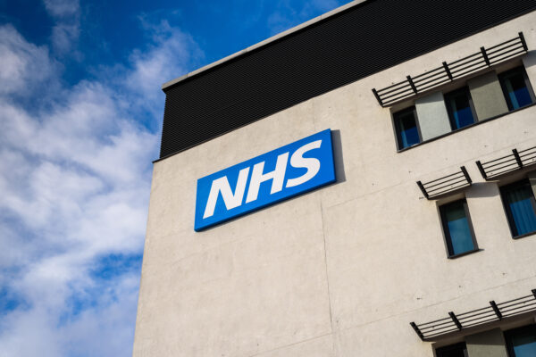 View of the NHS (National Health Service) logo on a hospital building