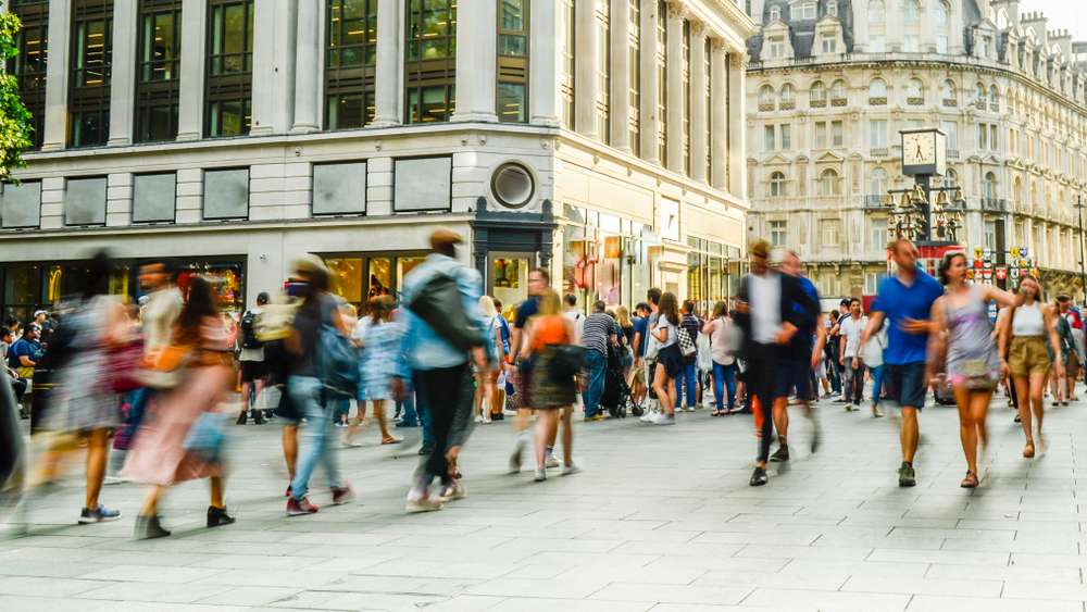 Retail Network Optimisation - Busy crowds of anonymous motion blurred shoppers on London street