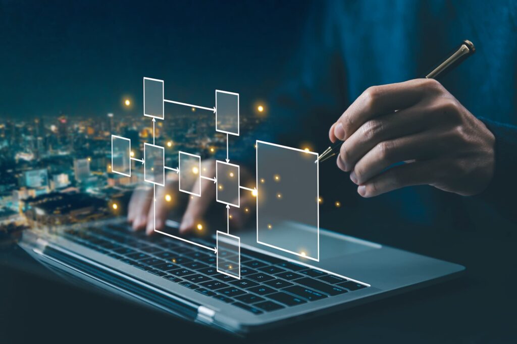 Solution design - A person using a stylus on a holographic interface with glowing nodes above a laptop keyboard.