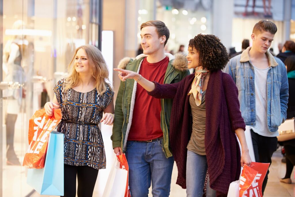 Predictive analytics and decisioning - A young group of people in a shopping centre looking at a shop window