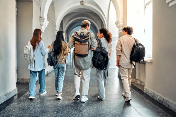 Lancaster University - Group of students walking together in a corridor at university