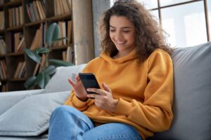 Nationwide - Woman viewing her online bank account on her mobile phone sitting on a sofa