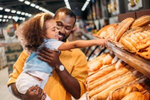 Advantage Smollan - Caring Parent holding child in a supermarket aisle