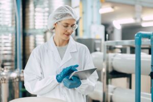 Perfetti Van Melle - Manufacturing worker inspecting machinery in a manufacturing plant