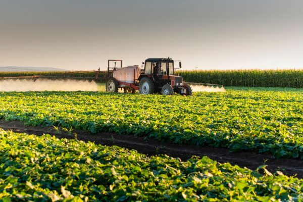 Agrovista - Tractor in a farm field harvesting