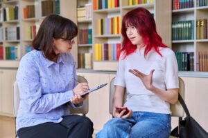 Milton Keynes Youth Offending Team - Teenager speaking to a youth worker
