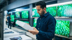Retail Marketing Group - Customer viewing electronic product