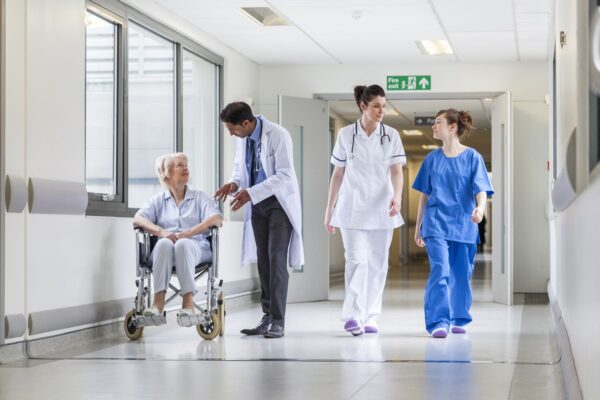 Wrightington, Wigan and Leigh Teaching Hospitals NHS Foundation Trust - Doctors and nurses walking down a hallway in a hospital area