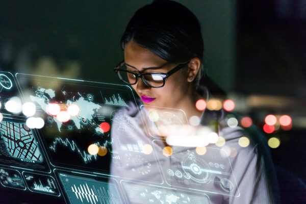 Businesswoman looking at futuristic interface screen.