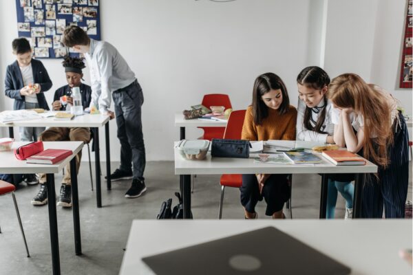 Students studying in a classroom with desks