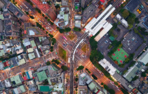 H3 Geospatial Tiling System - Top down view of a metro train arriving at an elevated station in Taipei