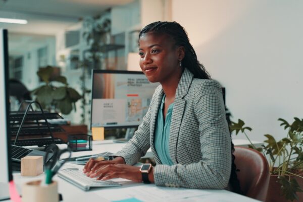 Women sitting at her desk typing on a keyboard