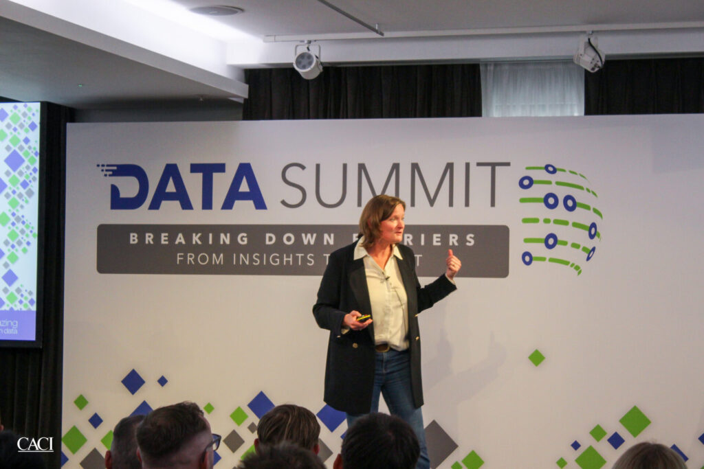 Sue MacLure presenting at CACI's Data Summit event.