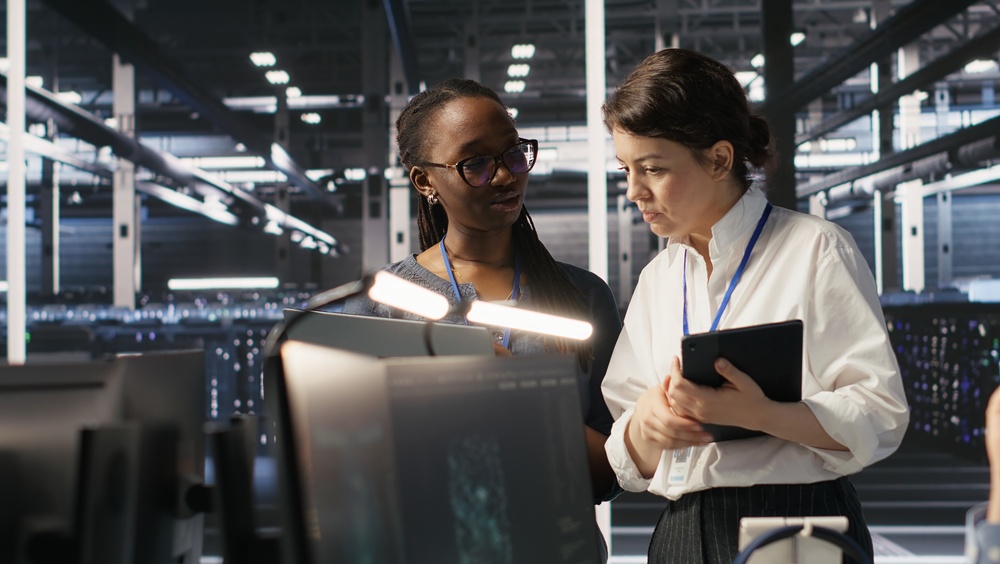 Managed SOC Services - Software developers working together in server farm, reviewing neural network code and LLM visualization dashboards
