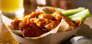 Plate of fried chicken coated in a red sauce